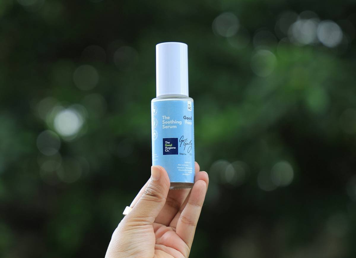Woman applying lightest weight tinted moisturizer with fingertips for natural, dewy finish
